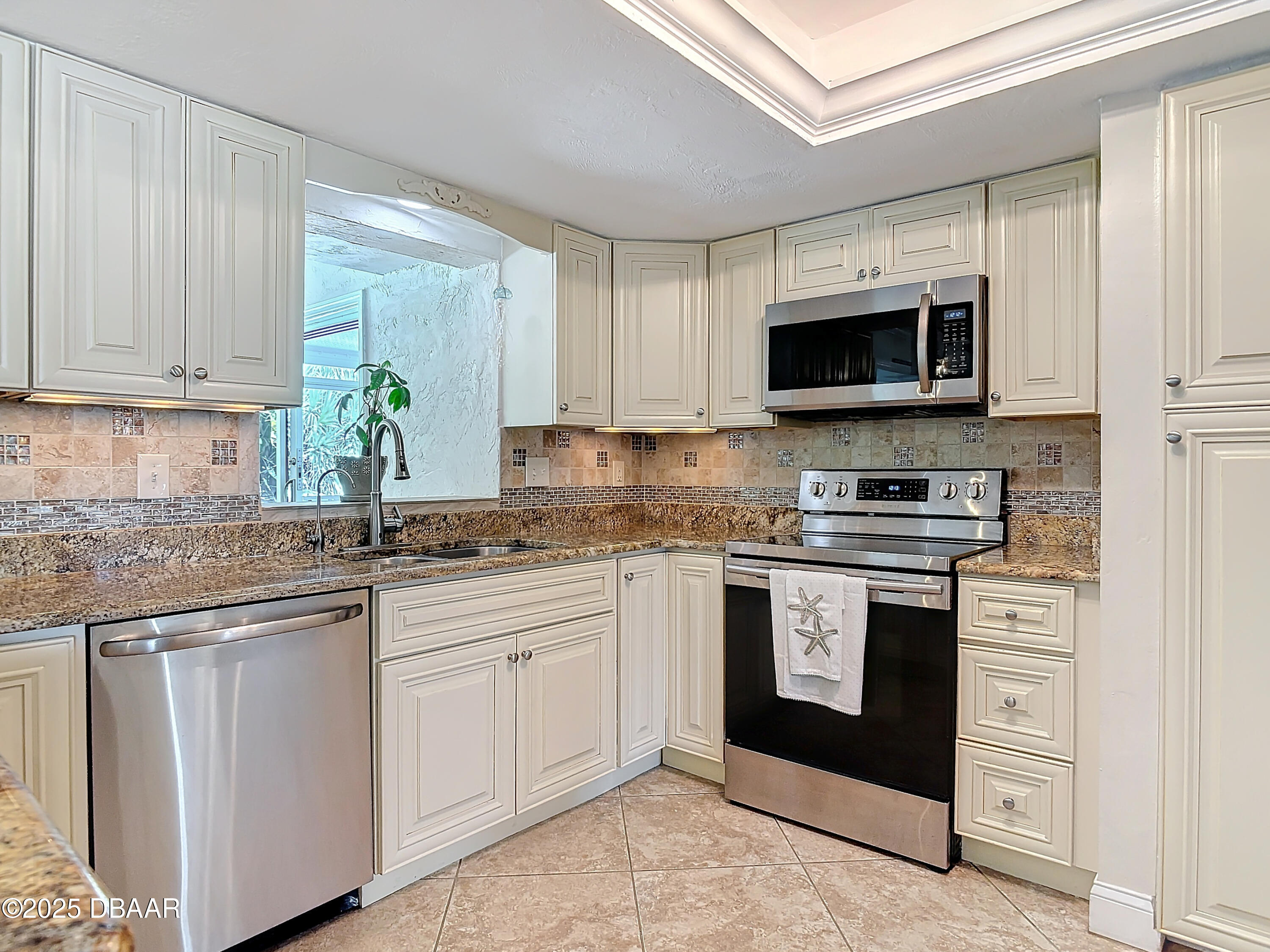 86 Rains Court Ponce Inlet, FL 32127 - Photo 20 of 71 a kitchen with stainless steel appliances granite countertop a stove a sink and a microwave
