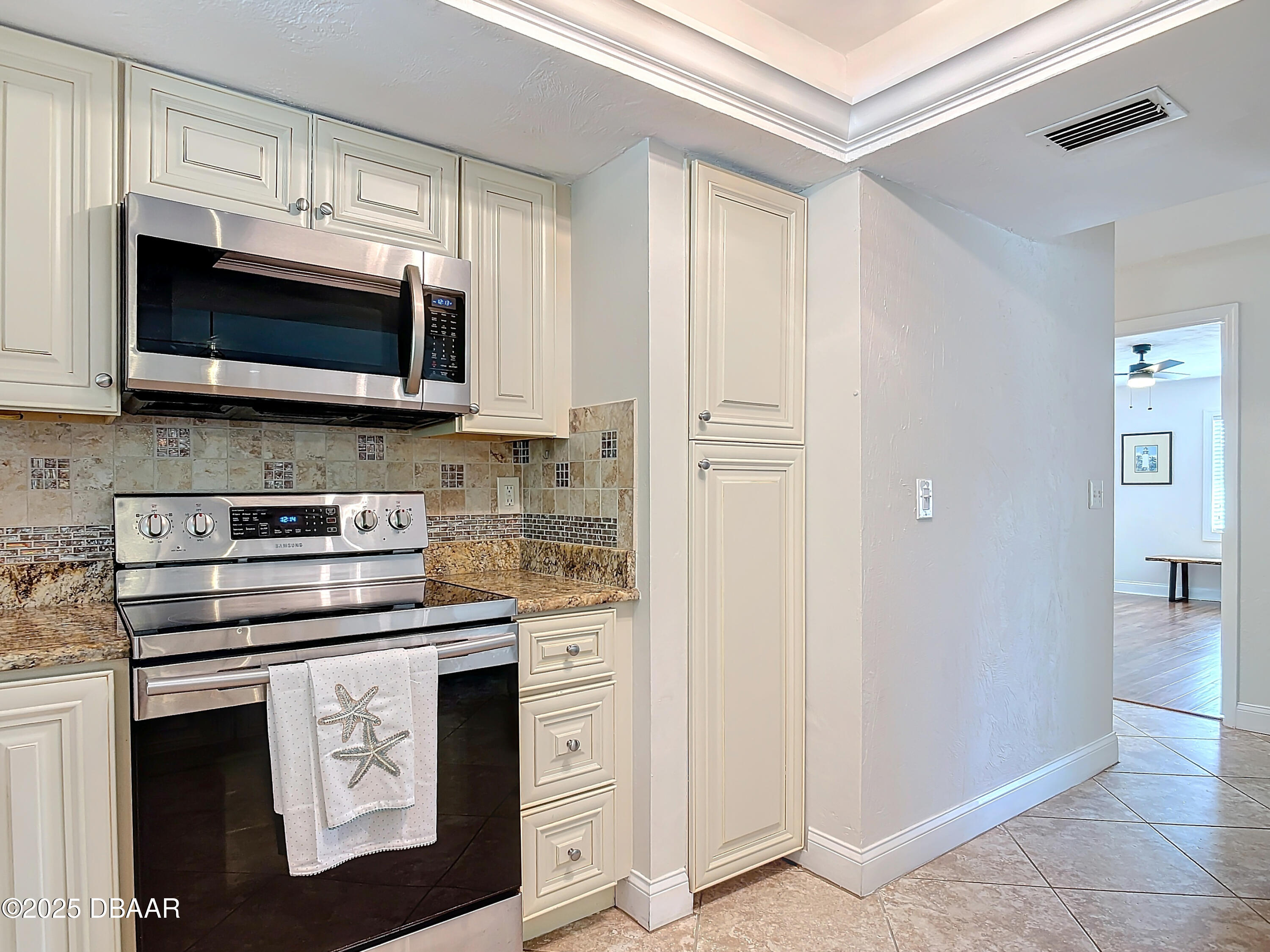86 Rains Court Ponce Inlet, FL 32127 - Photo 22 of 71 a kitchen with stainless steel appliances a stove a microwave a sink and cabinets