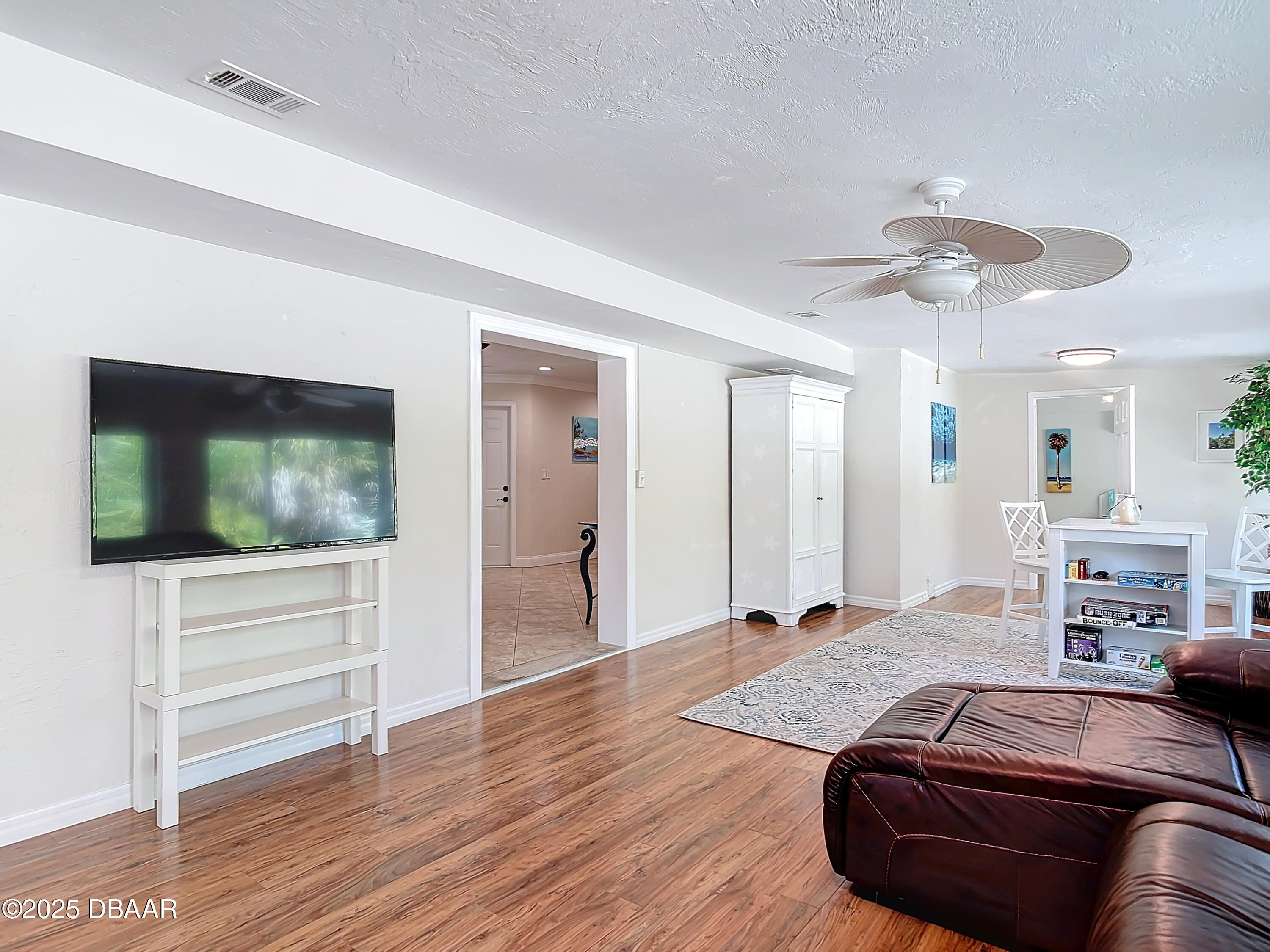 86 Rains Court Ponce Inlet, FL 32127 - Photo 28 of 71 a bedroom with furniture and a flat screen tv