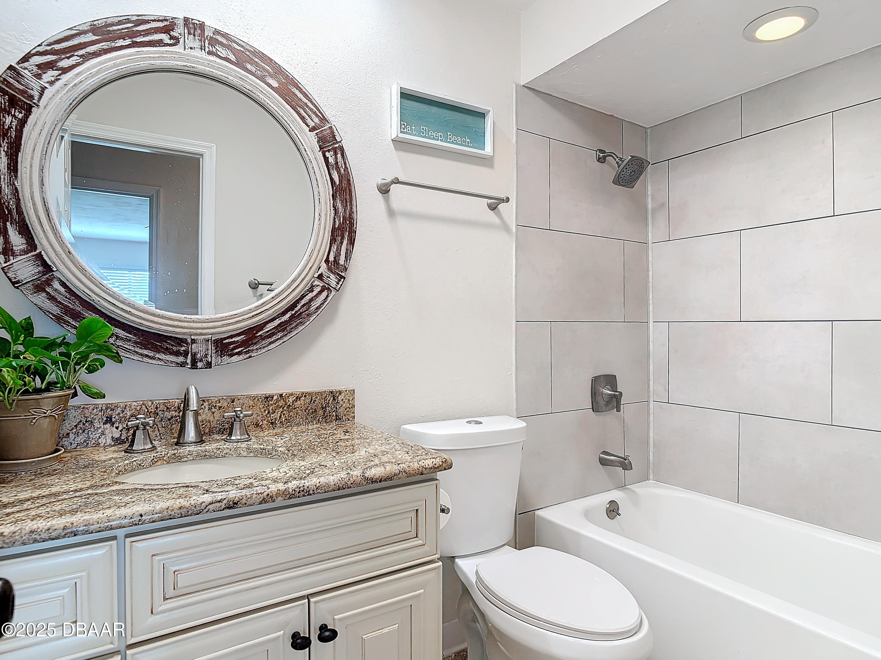 86 Rains Court Ponce Inlet, FL 32127 - Photo 38 of 71 a bathroom with a granite countertop toilet sink and mirror