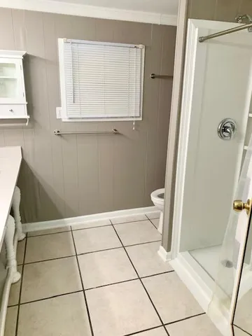 a bathroom with a sink a toilet and a shower