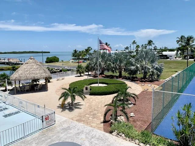 a view of a tennis court with sitting area