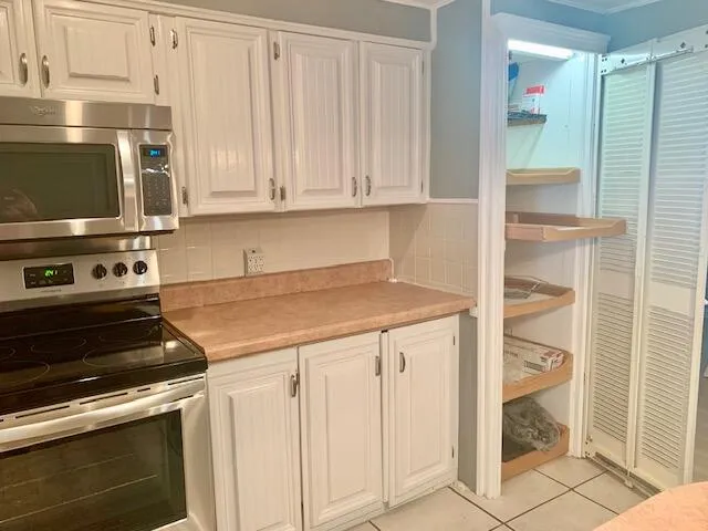 a kitchen with granite countertop a stove and a microwave