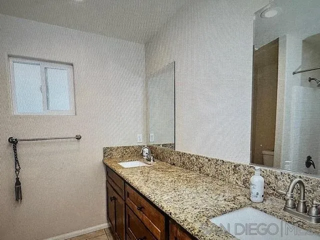 312 Chisolm Trail Imperial, CA 92251 - Photo 4 of 10 a bathroom with a granite countertop sink and a mirror