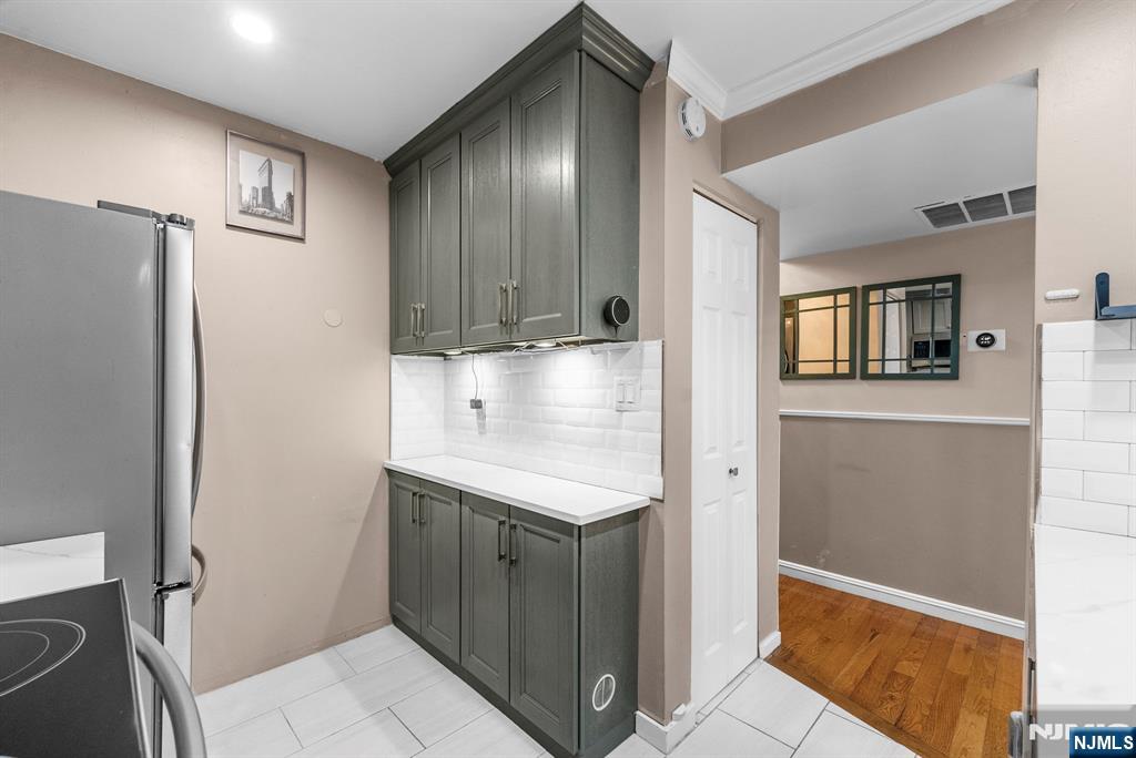 753 Summer, Unit 3D Newark, NJ 07104 - Photo 13 of 41 a kitchen with stainless steel appliances granite countertop a refrigerator and a stove