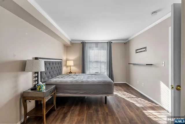 a view of a room with wooden floor and white walls