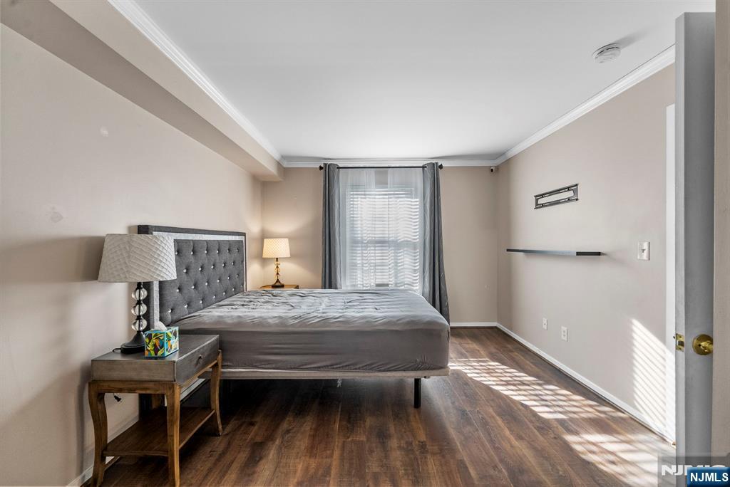 753 Summer, Unit 3D Newark, NJ 07104 - Photo 17 of 41 a bedroom with a bed and wooden floor