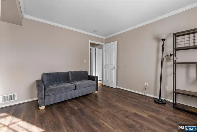 a bathroom with a granite countertop sink a mirror a toilet and shower
