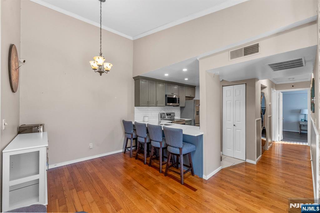 753 Summer, Unit 3D Newark, NJ 07104 - Photo 7 of 41 a view of a dining room and livingroom with furniture wooden floor a chandelier