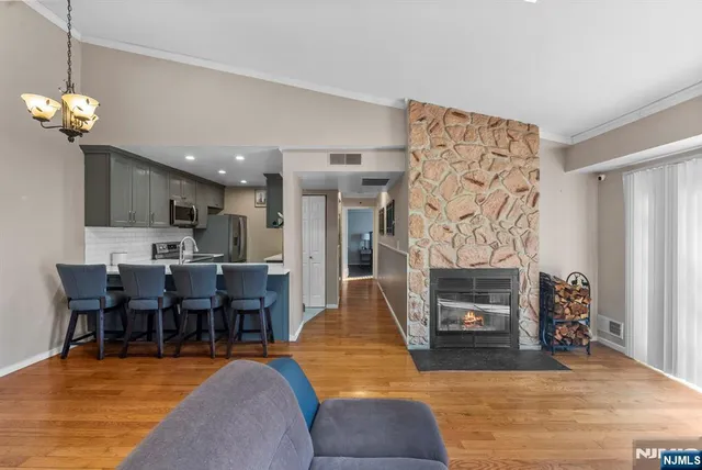 a kitchen with stainless steel appliances a sink a microwave a refrigerator and cabinets