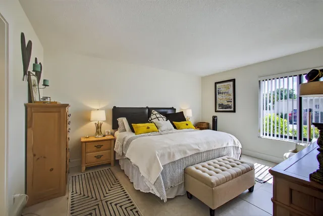 a bedroom with a bed couch and a window