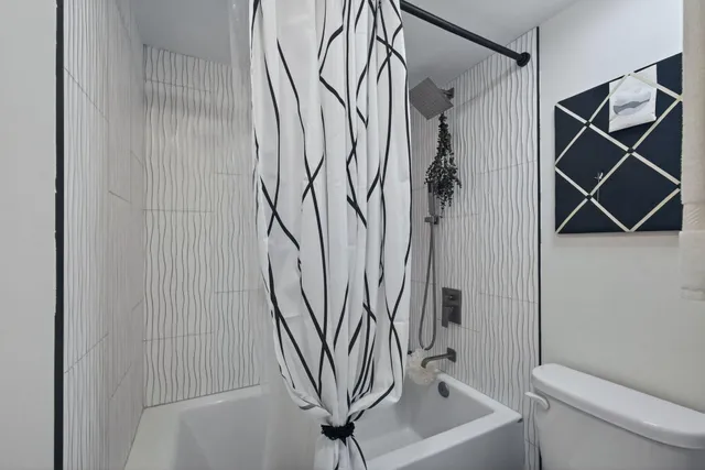 a bathroom with a shower and a toilet