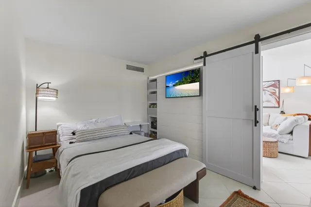 a bedroom with a bed and a mirror