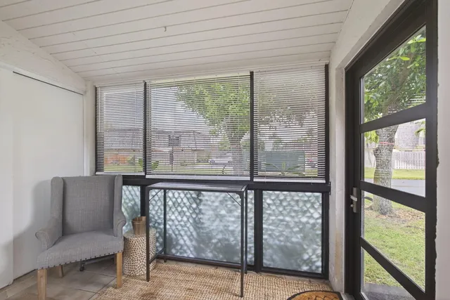 a view of a room with furniture and windows