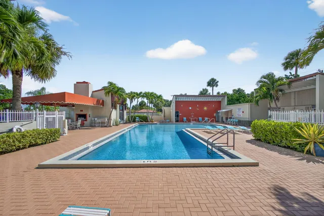 a view of swimming pool with outdoor seating and plants