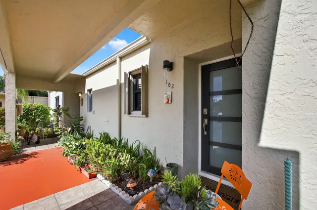 a house with potted plants in front of it