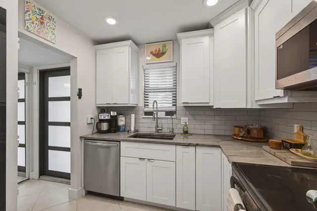 a kitchen with stainless steel appliances granite countertop a sink stove and cabinets
