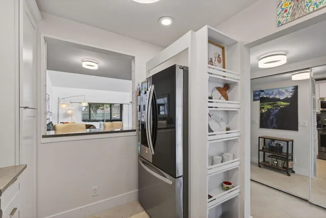 a kitchen with stainless steel appliances a refrigerator and cabinets