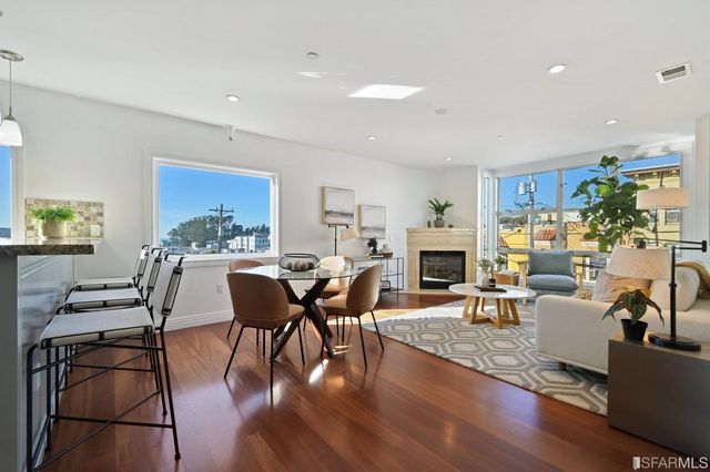 a living room with fireplace furniture and a wooden floor