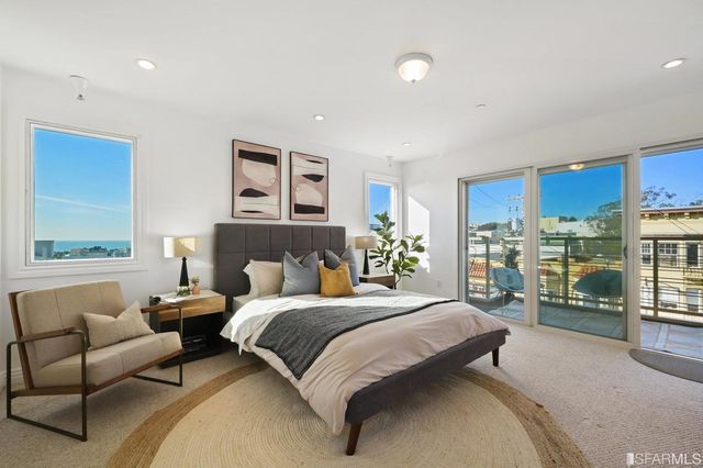 a spacious bedroom with a bed and a potted plant