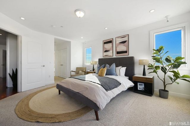 a bathroom with a tub a double vanity sink and mirror