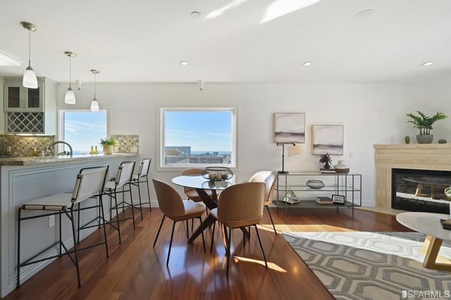 a view of a dining room with furniture window and wooden floor
