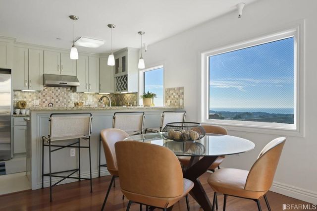 a dining room with furniture and wooden floor