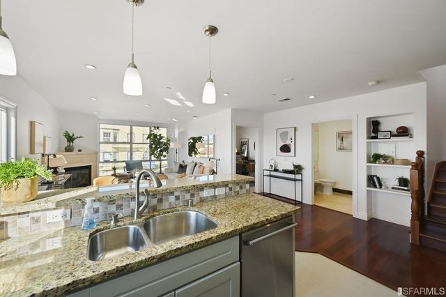 a kitchen with granite countertop stainless steel appliances and wooden cabinets