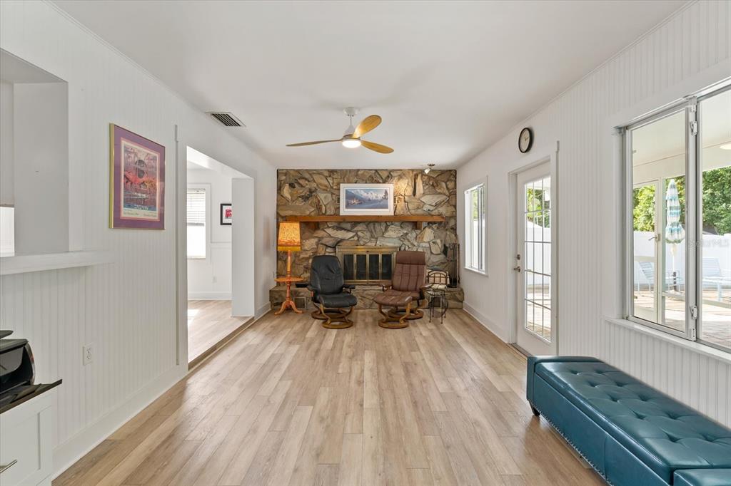 1700 Patricia Avenue Dunedin, FL 34698 - Photo 13 of 31 a living room with furniture and a chandelier