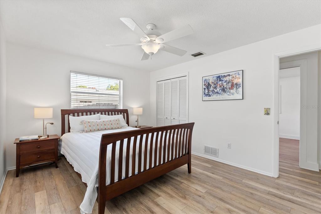 1700 Patricia Avenue Dunedin, FL 34698 - Photo 17 of 31 a bedroom with a bed and a chandelier