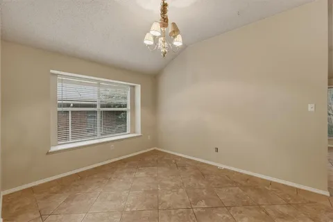 an empty room with a chandelier