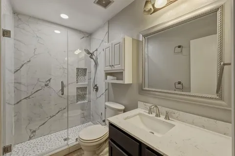 a bathroom with a sink toilet and shower