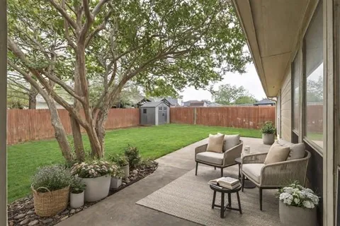 a view of a yard with furniture and a fire pit