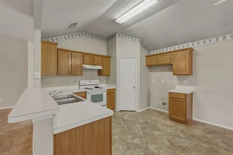 a kitchen that has a sink and a stove in it