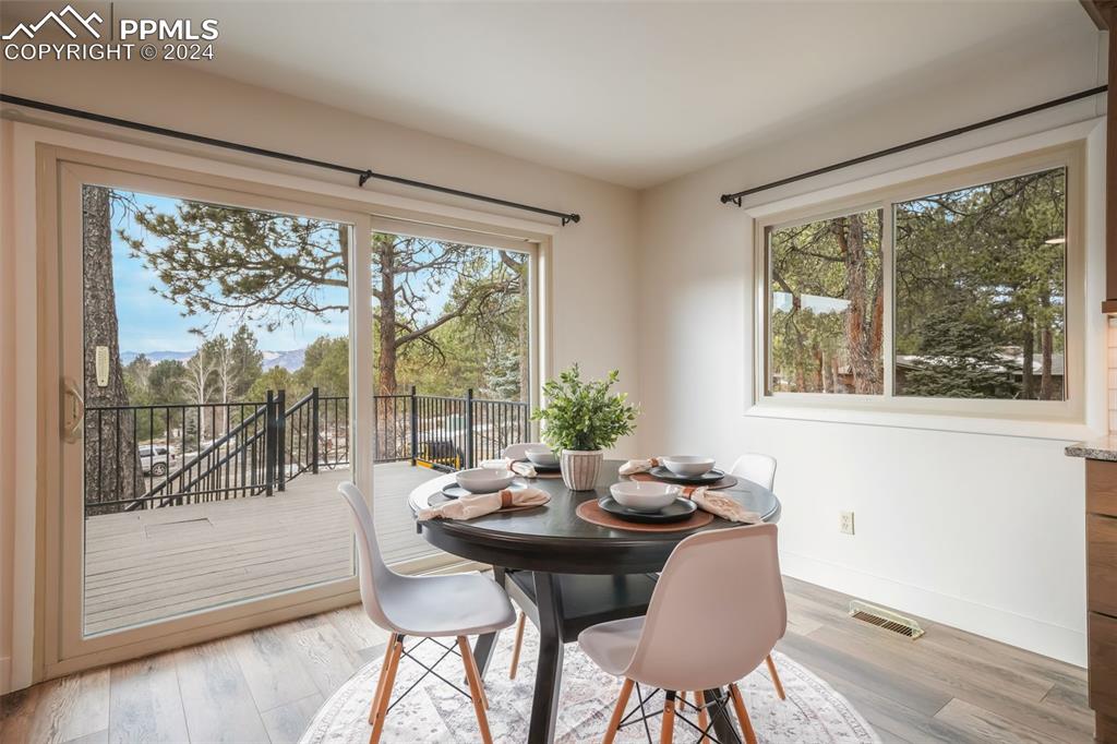 18585 Augusta Drive Monument, CO 80132 - Photo 11 of 50 a view of a dining room with furniture window and wooden floor