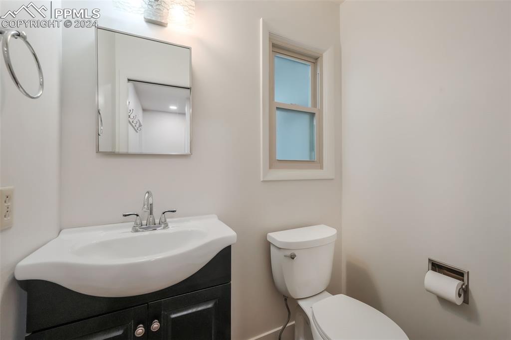 18585 Augusta Drive Monument, CO 80132 - Photo 14 of 50 a bathroom with a toilet a sink and mirror