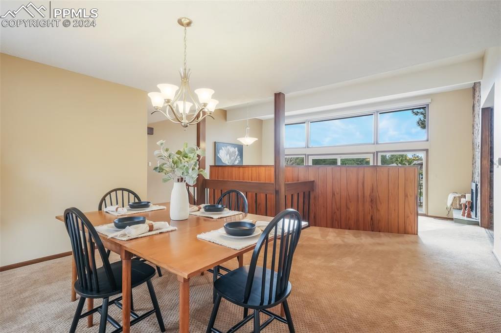 18585 Augusta Drive Monument, CO 80132 - Photo 20 of 50 a view of a dining room with furniture and chandelier