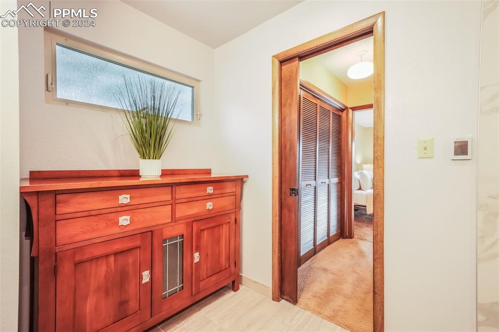 18585 Augusta Drive Monument, CO 80132 - Photo 38 of 50 a bedroom with a bed and a mirror on dresser