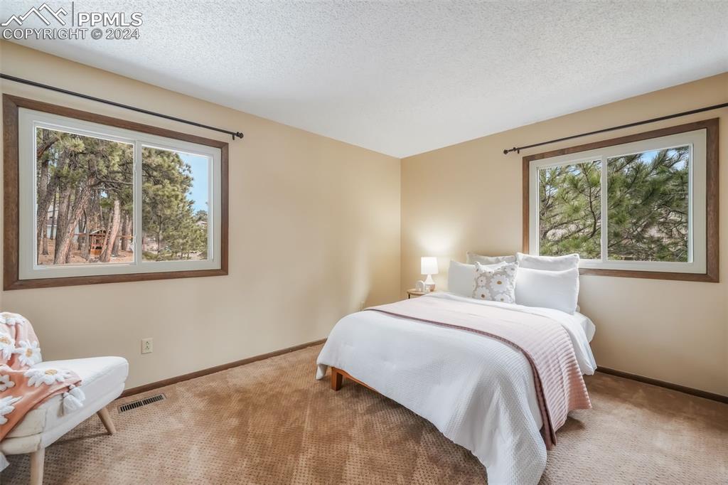 18585 Augusta Drive Monument, CO 80132 - Photo 43 of 50 a bedroom with a bed and a large window