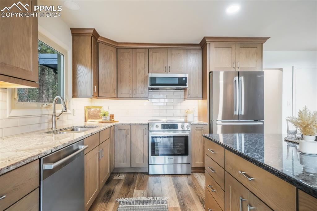 18585 Augusta Drive Monument, CO 80132 - Photo 5 of 50 a kitchen with stainless steel appliances granite countertop a sink stove and refrigerator