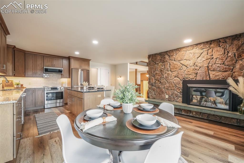 18585 Augusta Drive Monument, CO 80132 - Photo 7 of 50 a kitchen with a table chairs stove and kitchen island