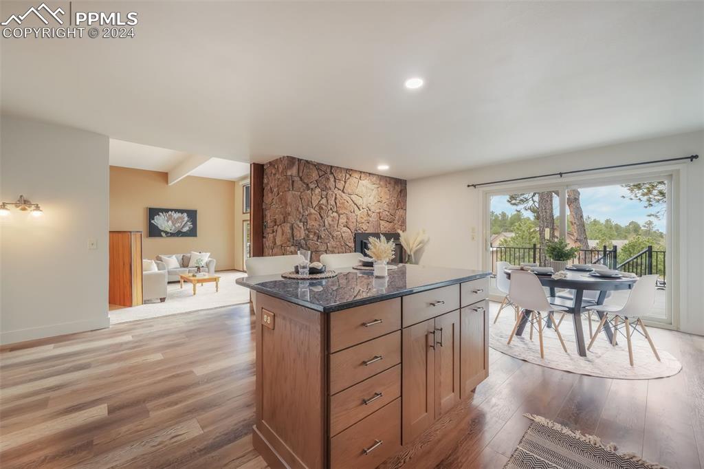 18585 Augusta Drive Monument, CO 80132 - Photo 8 of 50 a kitchen with a table chairs stove and wooden floor