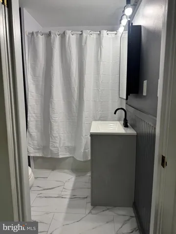 a bathroom with a sink and a shower curtain