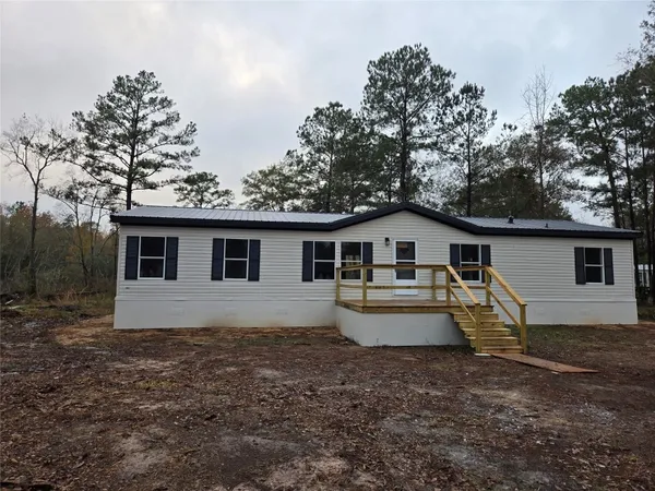 a kitchen with stainless steel appliances a refrigerator a sink dishwasher and a stove with wooden floor