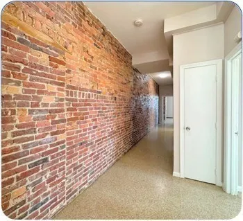 an empty room with a empty space and windows