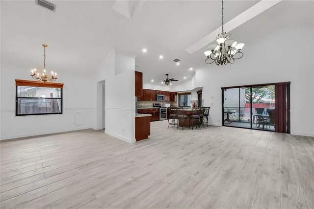 a view of a livingroom with furniture cabinet and a chandelier