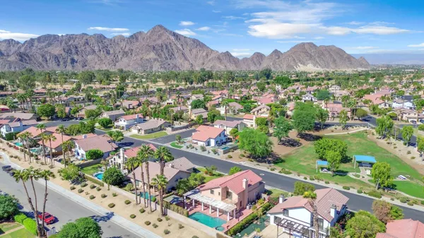 an aerial view of residential house and sandy dunes
