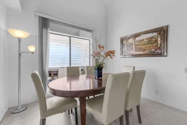 a view of a dining room with furniture and window
