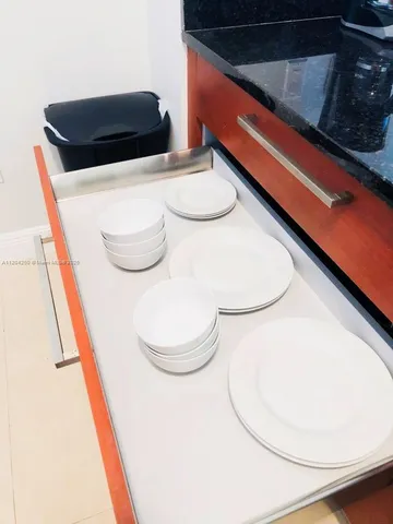 a table with chairs and stove in it