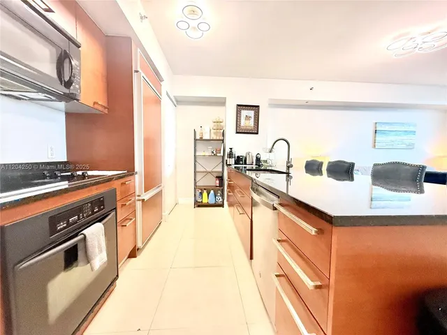 a living room with furniture wooden floor and a view of kitchen